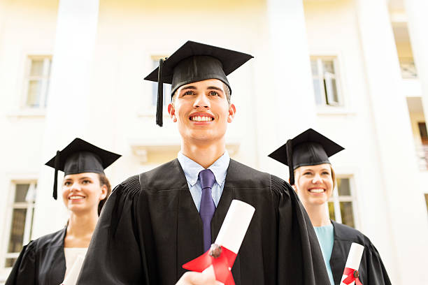 istock Happy Students Holding Diplomas Outside College Building 515450889