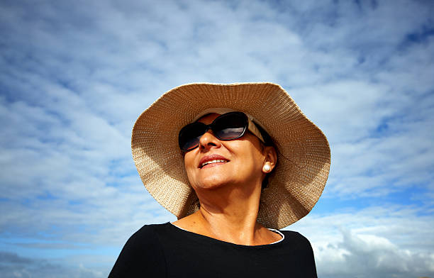 istock Mature smiling hispanic woman sunglasses and sunhat 515451417