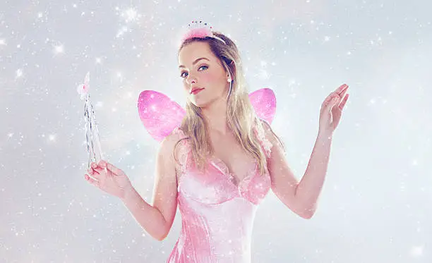 A cropped shot of a cute fairy dressed in pink
