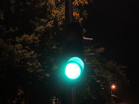 Traffic light at night-time showing green