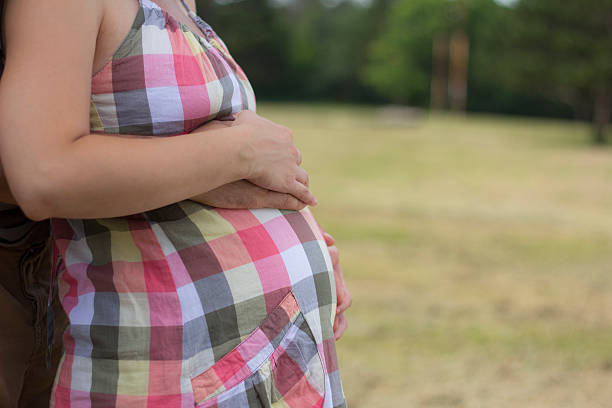 istock Mid section of a pregnant belly 515452795