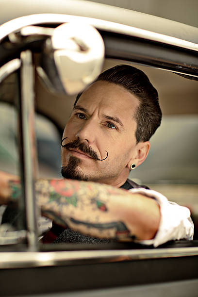 istock Man with moustaches driving  car 515453917