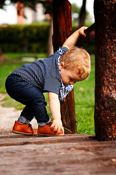 istock baby boy playing outdoors 515456185