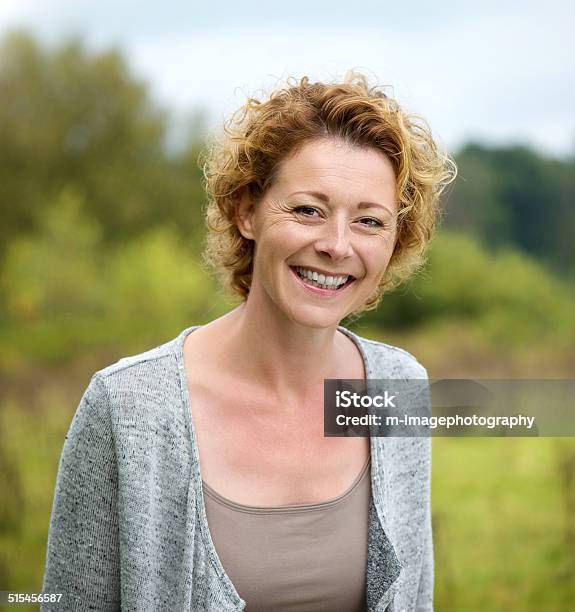 Beautiful Mature Woman Smiling In The Park Stock Photo - Download Image Now - Women, One Woman Only, Rural Scene