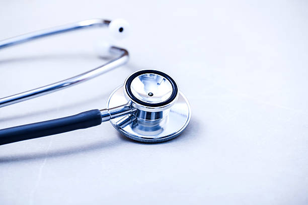 istock Stethoscope on white table with shallow depth of field . 515469404