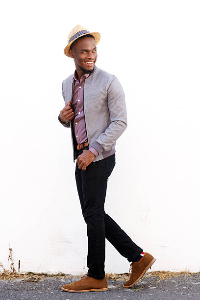 istock Smiling male fashion model walking and glancing back 515472566