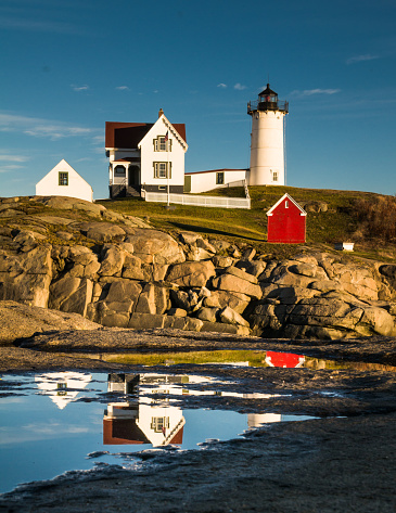 Cape Neddick Lighthouse(1879) ,located on a small island known as The Nubble in York Maine is reflected on a small mainland tide pool.