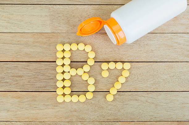 istock Yellow pills forming shape to B7 alphabet on wood background 515474344