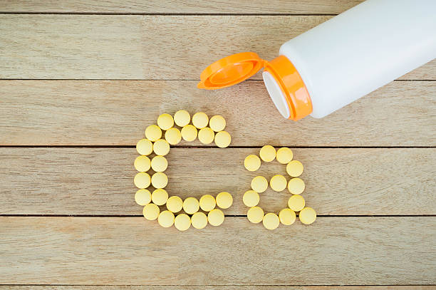 istock Yellow pills forming shape to Ca alphabet on wood background 515474602