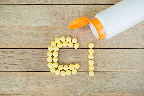 istock Yellow pills forming shape to Cl alphabet on wood background 515474786