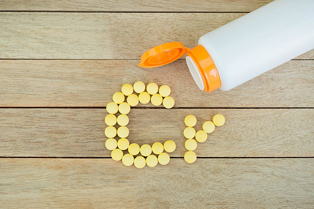 istock Yellow pills forming shape to Cr alphabet on wood background 515474876