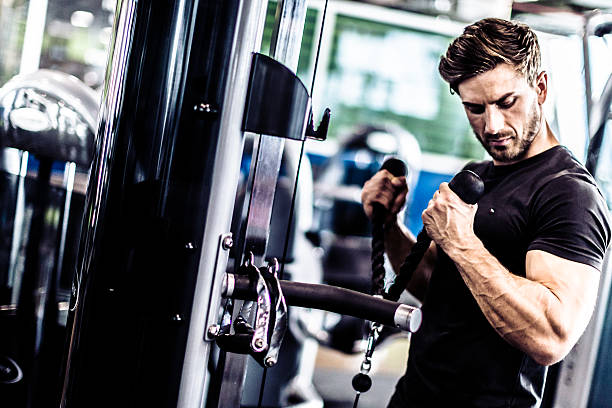 istock Muscular Fit Man Exercising in a Gym 515475126