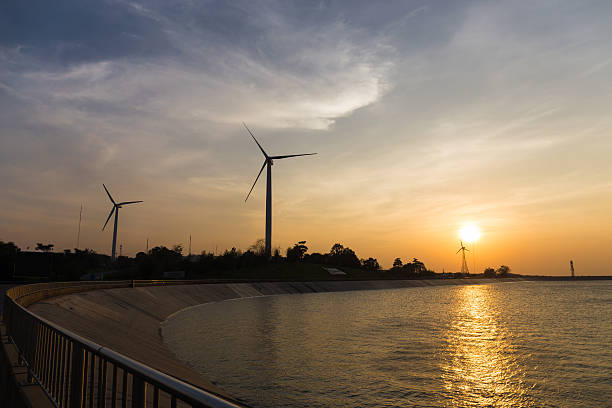 istock power generator wind turbines at sunset with reservoir 515475346