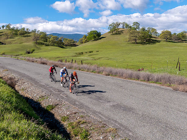 Cyclists road racing in spring foothills Chico, California, USA -  February 28, 2015:  Trio of Pro/1/2 category cyclists during the road race stage at the Chico Stage Race in Northern California. chico california photos stock pictures, royalty-free photos & images