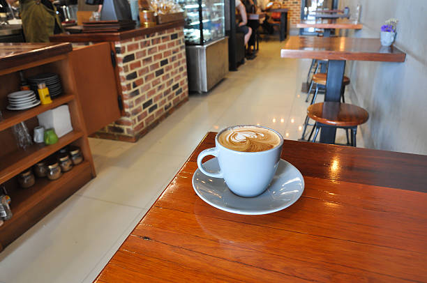 white cup of hot coffee on wooden in coffee shop, white cup of hot coffee on woodenwhite cup of hot coffee on wooden table in coffee shop