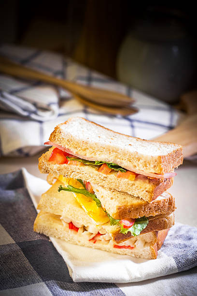 Sandwich on wood table with spot lighting. Sandwich on wood table with spot lighting,shallow Depth of Field,Focus on sandwich. granary toast stock pictures, royalty-free photos & images