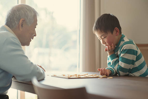 istock Grandfather and grandson playing with Japanese chess 515477040