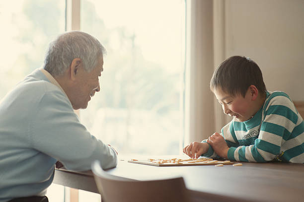 istock Grandfather and grandson playing with Japanese chess 515477082
