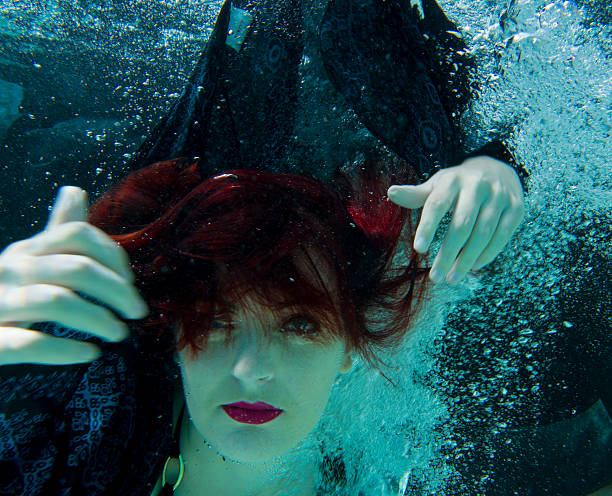 istock red hair over eyes underwater 515478430