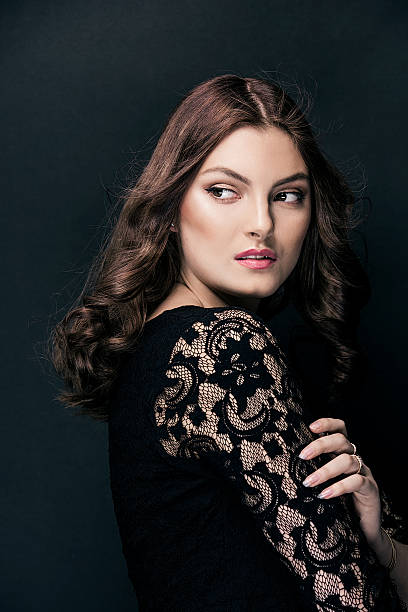 istock Beautiful young woman on black 515480002