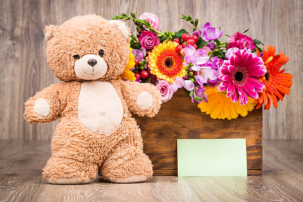 istock Bunch of flowers and a teddy bear 515481910