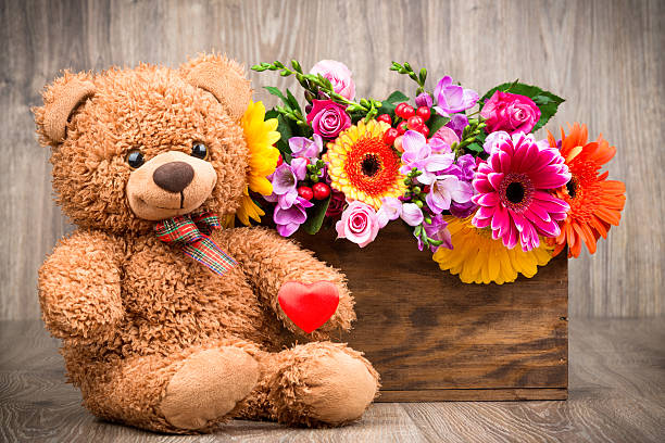 istock Bunch of flowers and a teddy bear 515482002