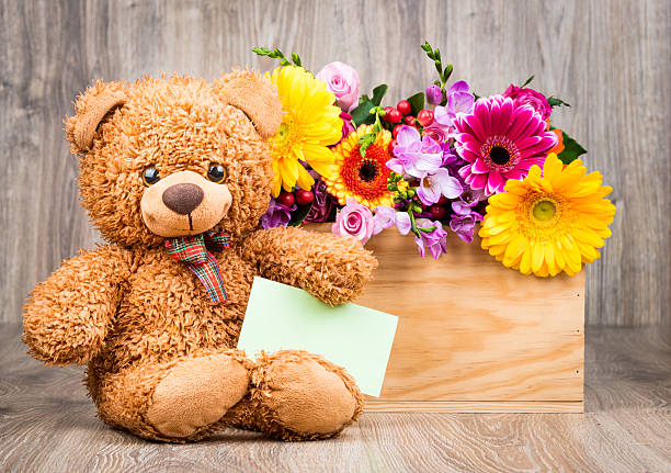 istock Bunch of flowers and a teddy bear 515482048