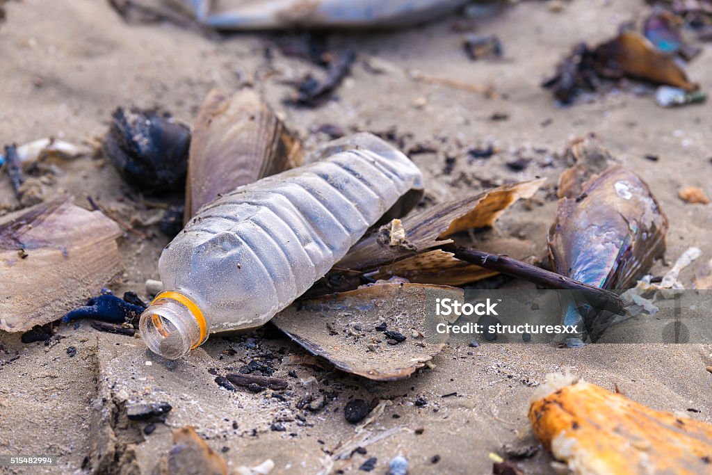 Beach pollution. Plastic bottles and other trash on sea beach Plastic Stock Photo