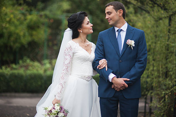 istock Happy wedding couple walking in a botanical park 515483384