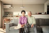 Elderly Man and Woman Sitting on Couch
