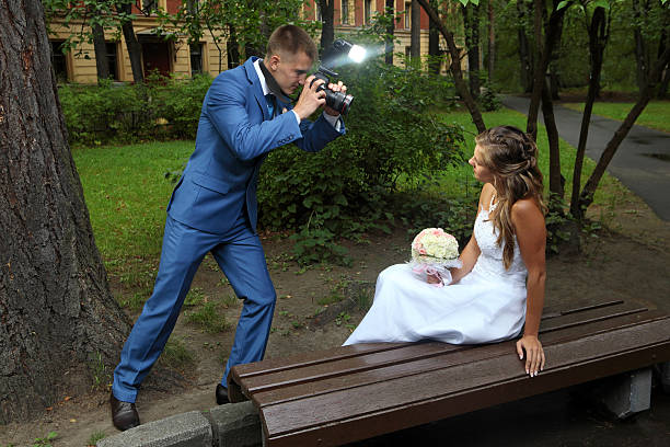 istock Wedding photo shoot, a newlywed with camera, take pictures bride. 515515185