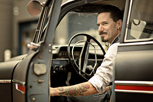 istock retro man with long moustaches sitting in car 515515251