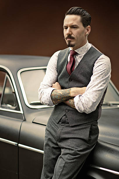 istock Retro dressed man with moustaches standing next to car 515515291