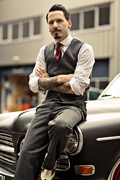 istock Retro dressed man with moustaches sitting on his car 515515315
