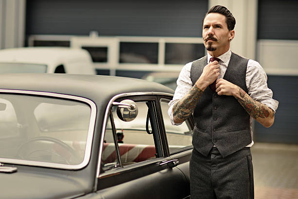 istock Retro dressed man with moustaches posing next his car 515515325