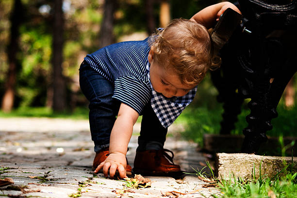istock baby boy playing outdoors 515515467