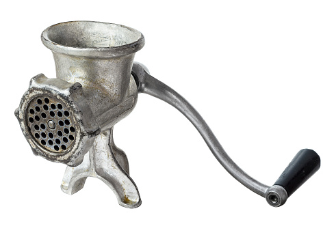 Old manual  iron meat mincer isolated on white background. File contains a clipping path.