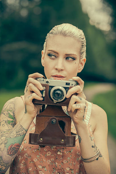 istock Blonde woman with the vintage rangefinder 515516191