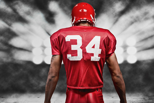 Rear view of American football player floodlighthttp://www.twodozendesign.info/i/1.png