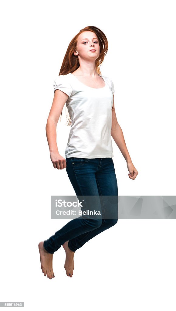 Jumping girl in a white T-shirt. Jumping girl in a white T-shirt. Isolated on white background Adult Student Stock Photo