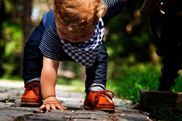 istock baby boy playing outdoors 515517357