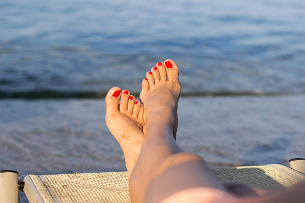 istock Beautiful female legs on the beach 515517657