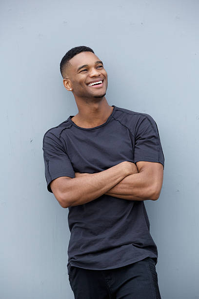 istock Young man laughing with arms crossed 515518569