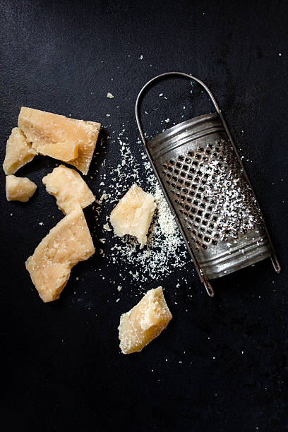 Parmesan cheese with a grater stock photo