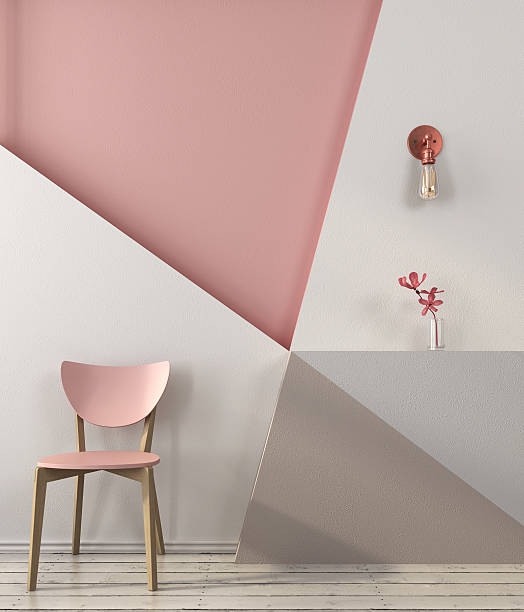 Pink chair on the background of a geometric wall Pink chair on the background of a wall with geometric shapes in pink and gray colors copper wall stock pictures, royalty-free photos & images