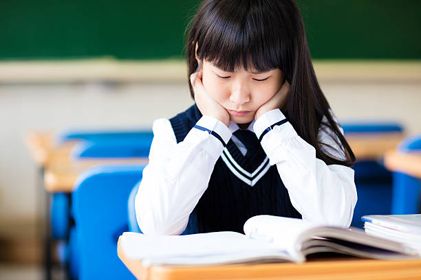 istock Stressed Student Of High School Sitting in classroom 515520664
