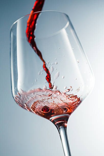 istock Red wine pouring in glass 515520872