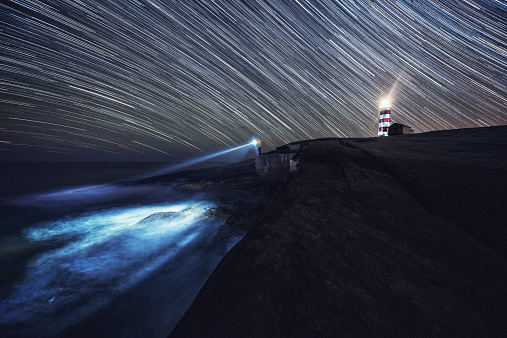 A fisherman searches the Atlantic for a friend lost at sea on the shores of Sambro Island.  Long exposure shot at high iso.