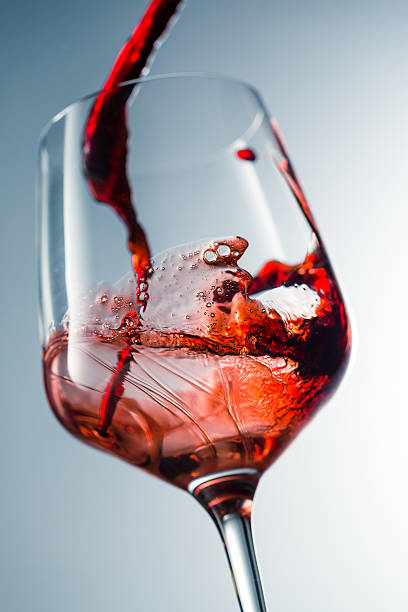 istock Red wine pouring in glass 515521064