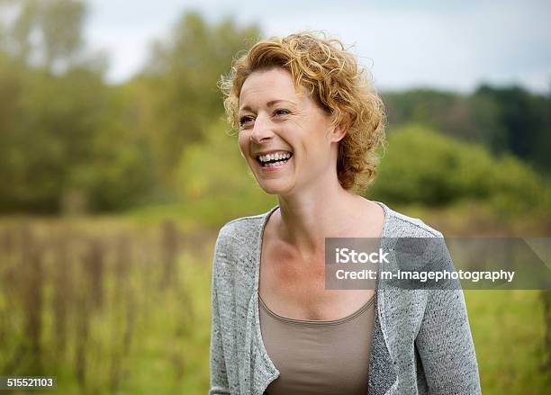 Smiling Middle Aged Woman Outdoors Stock Photo - Download Image Now - Women, Outdoors, Mature Women